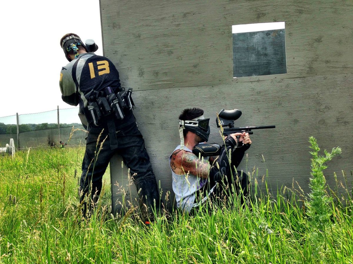 Tony, number 13, covers one side of a wall while a teammate takes the other at the park, July 2013.