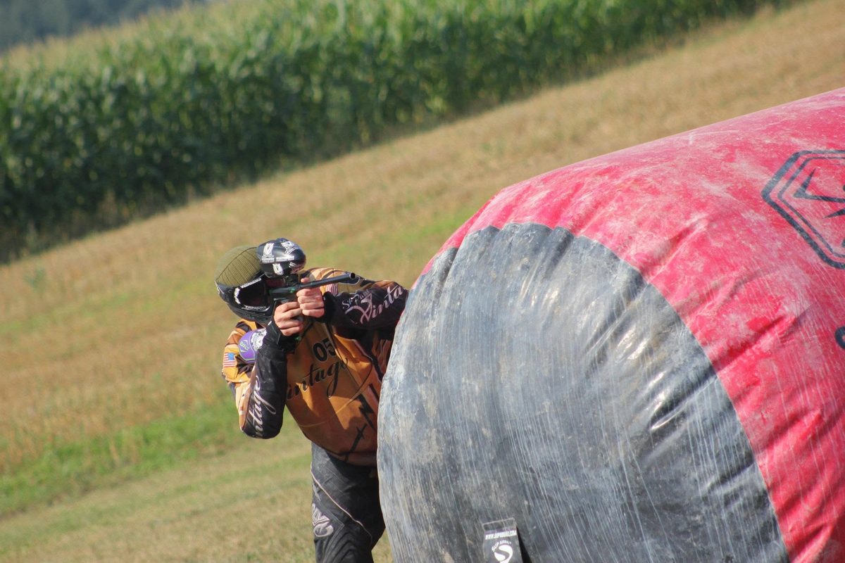 Tony, in the gold St. Paul Vintage 05, leans out from a big inflatable beside a cornfield, July 2012.