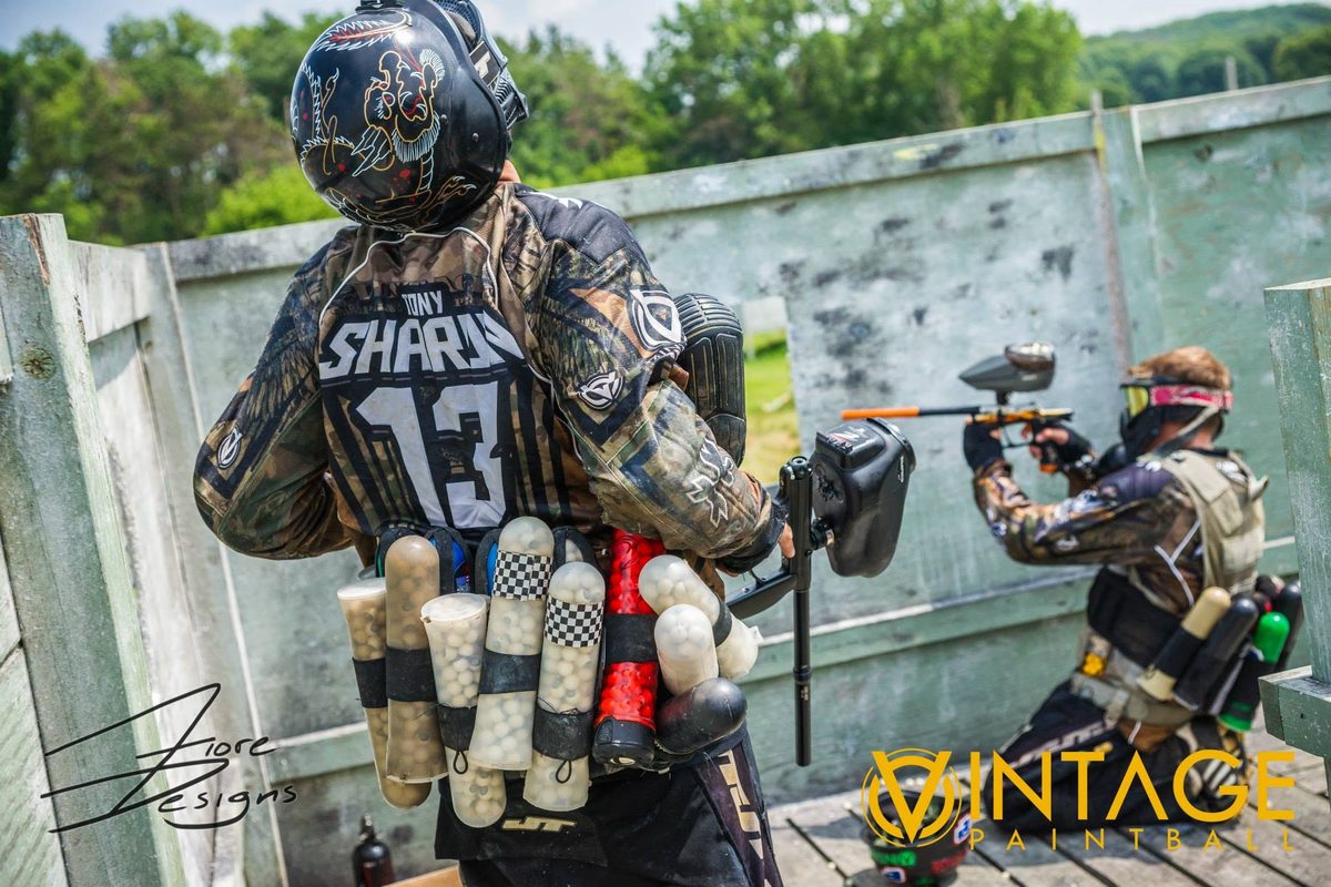 Tony, pods loaded and his name across his back, holds the fort beside a teammate at the 2014 Vintage Big Game.