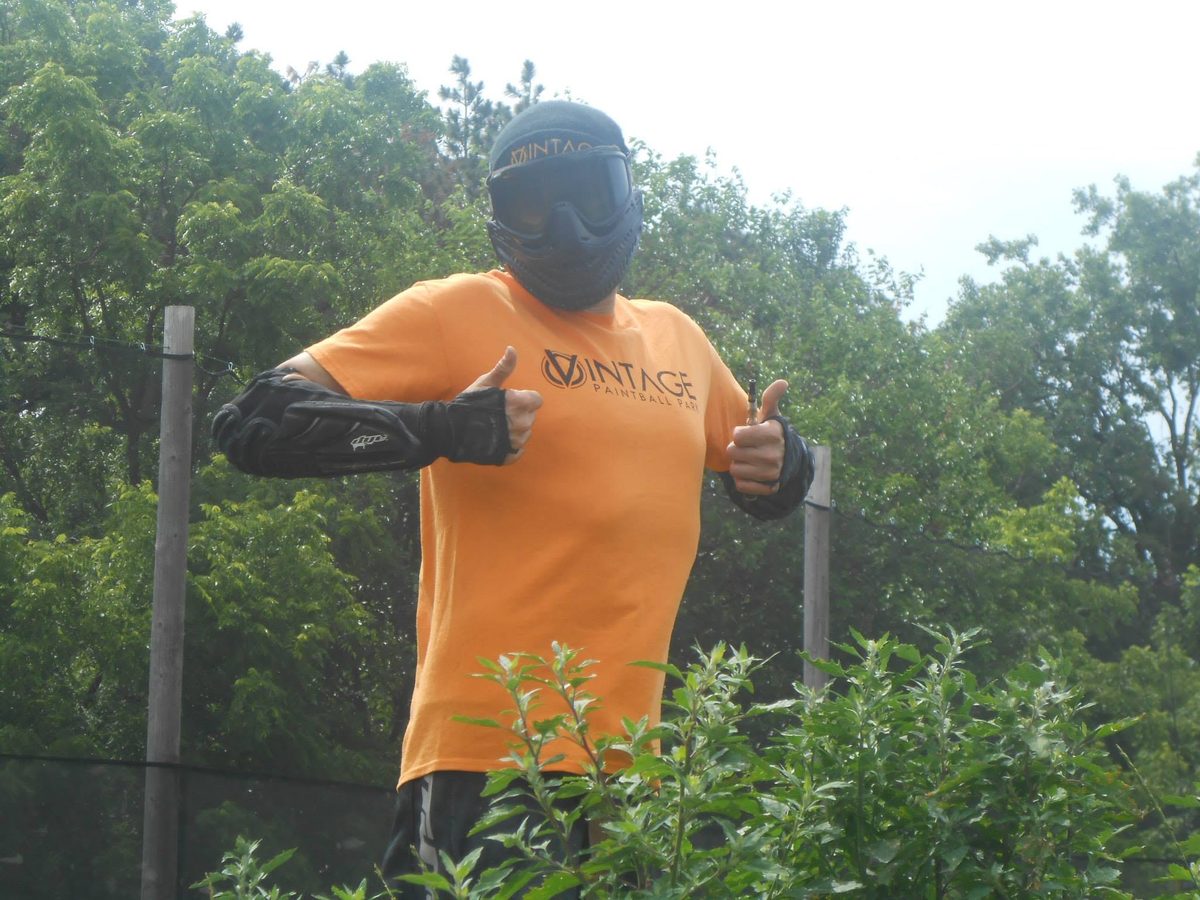 Tony gives two thumbs up in an orange Vintage Paintball Park shirt at the July 2013 CQC, where he believes he was head ref.