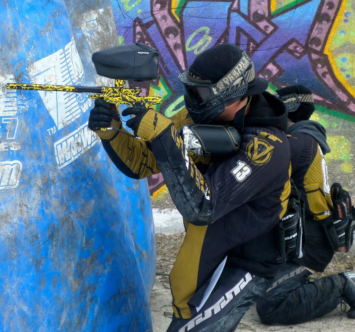 Tony, 13 on his chest, aims around a blue inflatable in front of the park's graffiti wall, March 2014.