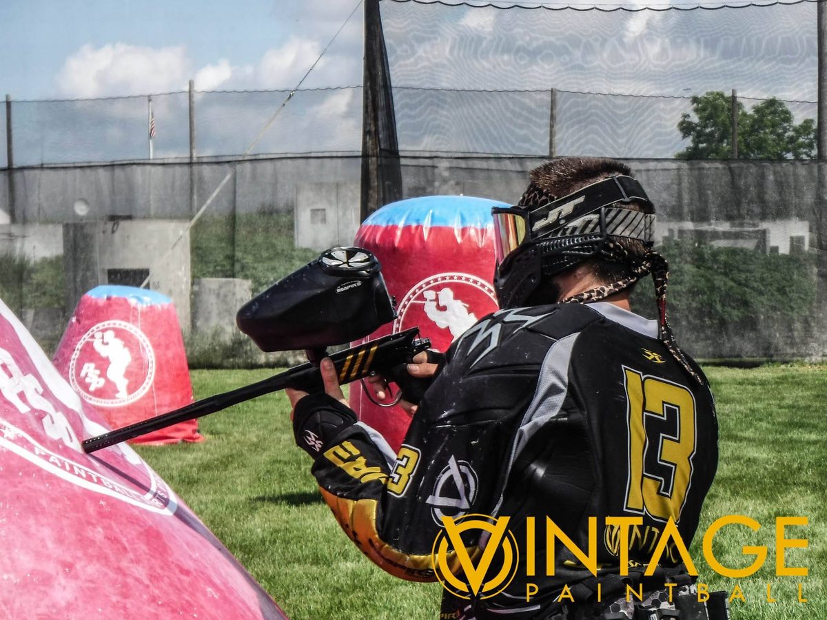 Tony, gold 13 on his back, aims past a PSP inflatable in Vintage black and gold, June 2015.
