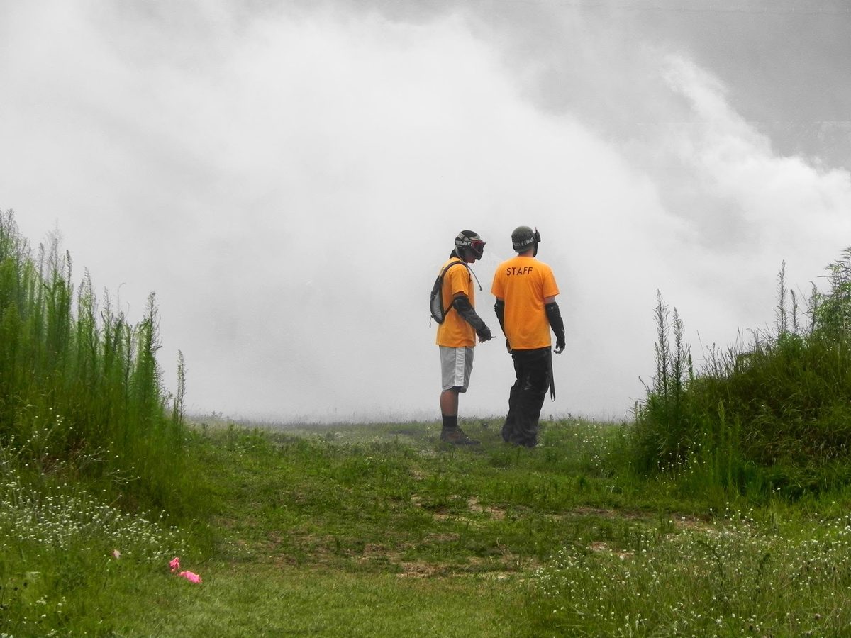 Tony and a fellow staff member watch smoke roll across the field, July 2012.