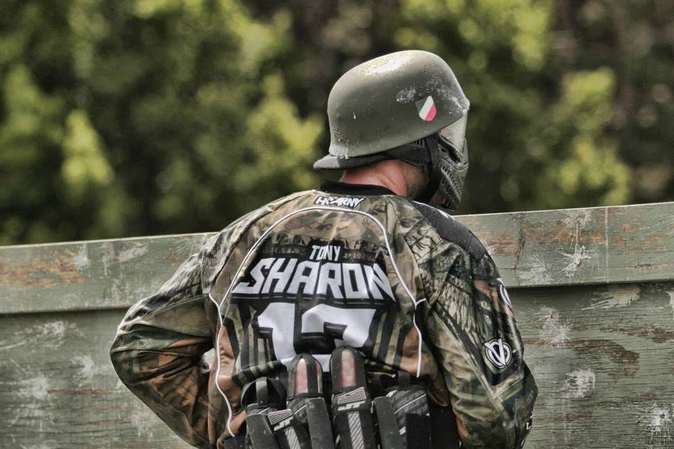 Tony, his name across his back and a WWII-style helmet on, looks over a plywood wall at the 2013 Vintage Big Game.